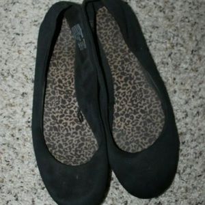 Well worn black flats with leopard insoles